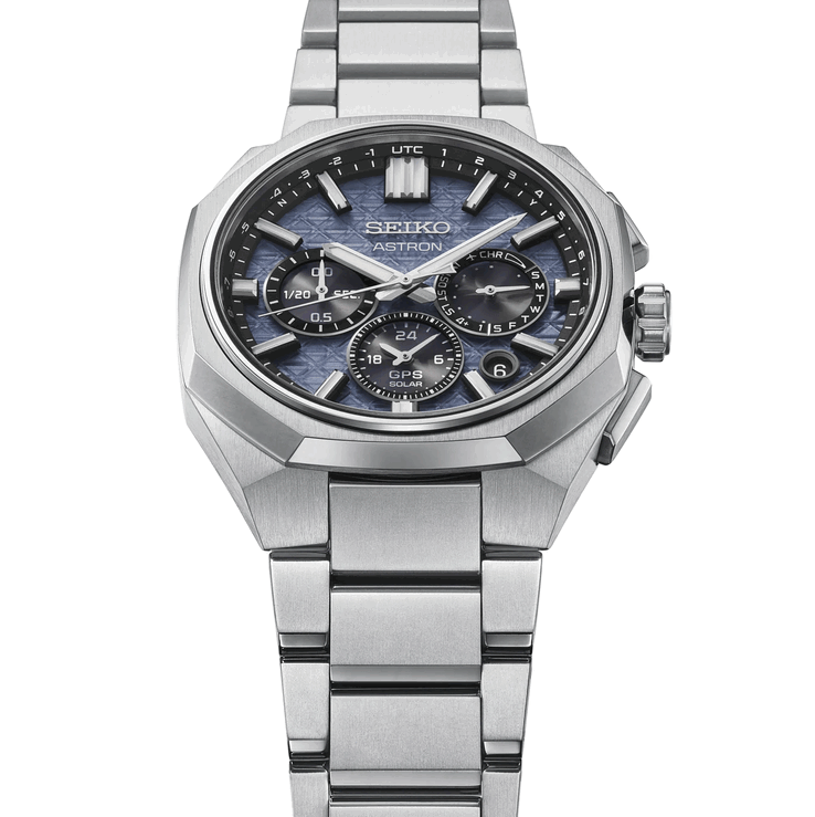 Seiko Astron HAB001'in yönlü titanyum çerçevesini, entegre bileziğini ve dokulu mavi kadranını gösteren açılı ön görünümü.