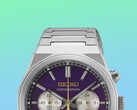 Seiko HGK003 modelinin üst yarısının yakın çekimi; köşeli paslanmaz çelik kasa, bilekliğin üst halkaları, üst düğmeler ve canlı yeşil ile mavi gradyan arka planın önünde yer alan mor kadranın üst kısmı öne çıkarılmıştır.