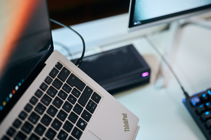 Arka planda Aorus eGPU'nun bulunduğu, Lenovo ThinkPad X9 dizüstü bilgisayarın yan bağlantı noktasına takılı bir Thunderbolt 5 kablosunun makro çekimi.