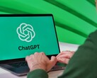 Ekranında ChatGPT logosu görünen bir dizüstü bilgisayarda yazan kişi