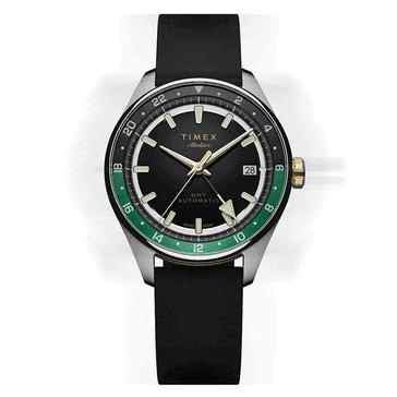 Timex Atelier GMT Première M1a with a black dial, green 24-hour GMT ring, and black NBR rubber strap.