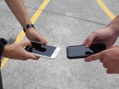 Teslim sırasında iki akıllı telefonu yan yana tutan iki kişi