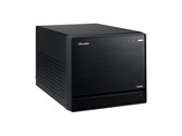Görsel, minimal bir tasarıma sahip siyah bir küp gibi görünen Shuttle XPC Mini PC'nin kafa üstü görünümünü gösteriyor. 