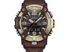 G-Shock Mudmaster GG-B100XMH-5A modelinin açık sarı altın ve kahverengi kasası ile çerçevesini gösteren yakın çekim fotoğrafı.