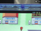 Pokémon çalıştıran şeffaf mavi FPGBA SP el konsolunun yakın çekimi; 59.74 FPS sayacı görünüyor.