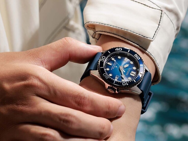 Maviye doğru gradyanlı kadranı ve mavi kayışı olan Citizen Promaster Marine BN0267-04L model saatini bileğinde takan kişi.