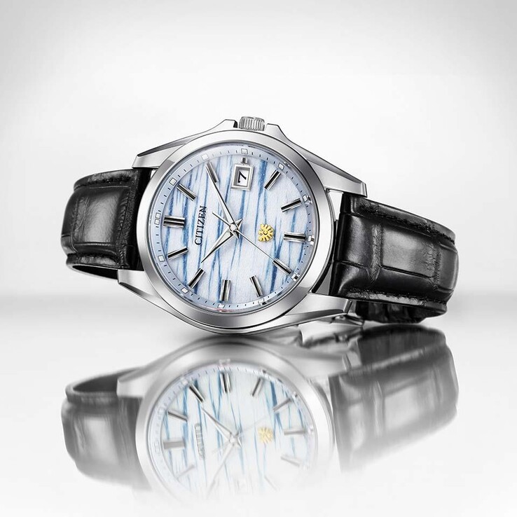 Citizen AQ4090-08A, yansıtıcı bir yüzeyin üzerinde dururken, indigo renkli washi kağıt kadranı ve siyah deri kayışı öne çıkıyor.